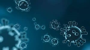 Corona - Darstellung Viren auf blauem Hintergrund - Infektionsrisiko verringern