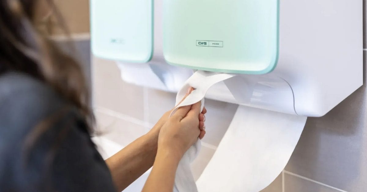 2 x nebeneinander: Handtuchspender CWS PureLine Dry mit Dame, die sich die Hände trocknet